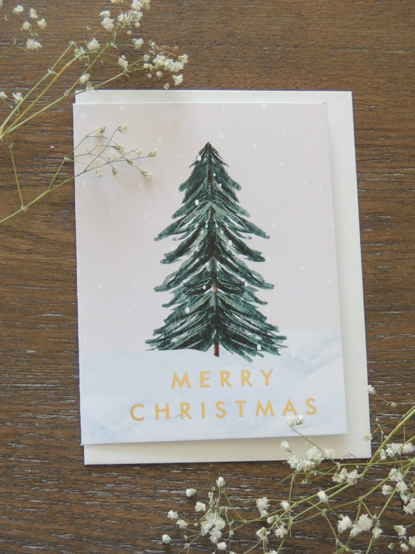 Christmas card with tree and gold words 'Merry Christmas"