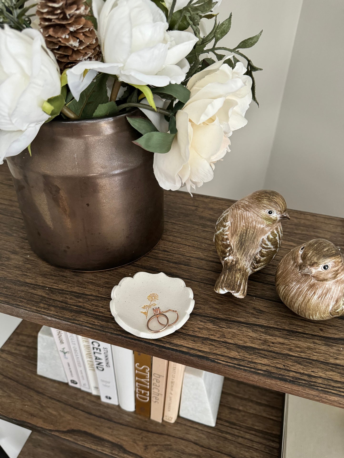 white clay royal themed edge ring dish with gold daisy in center