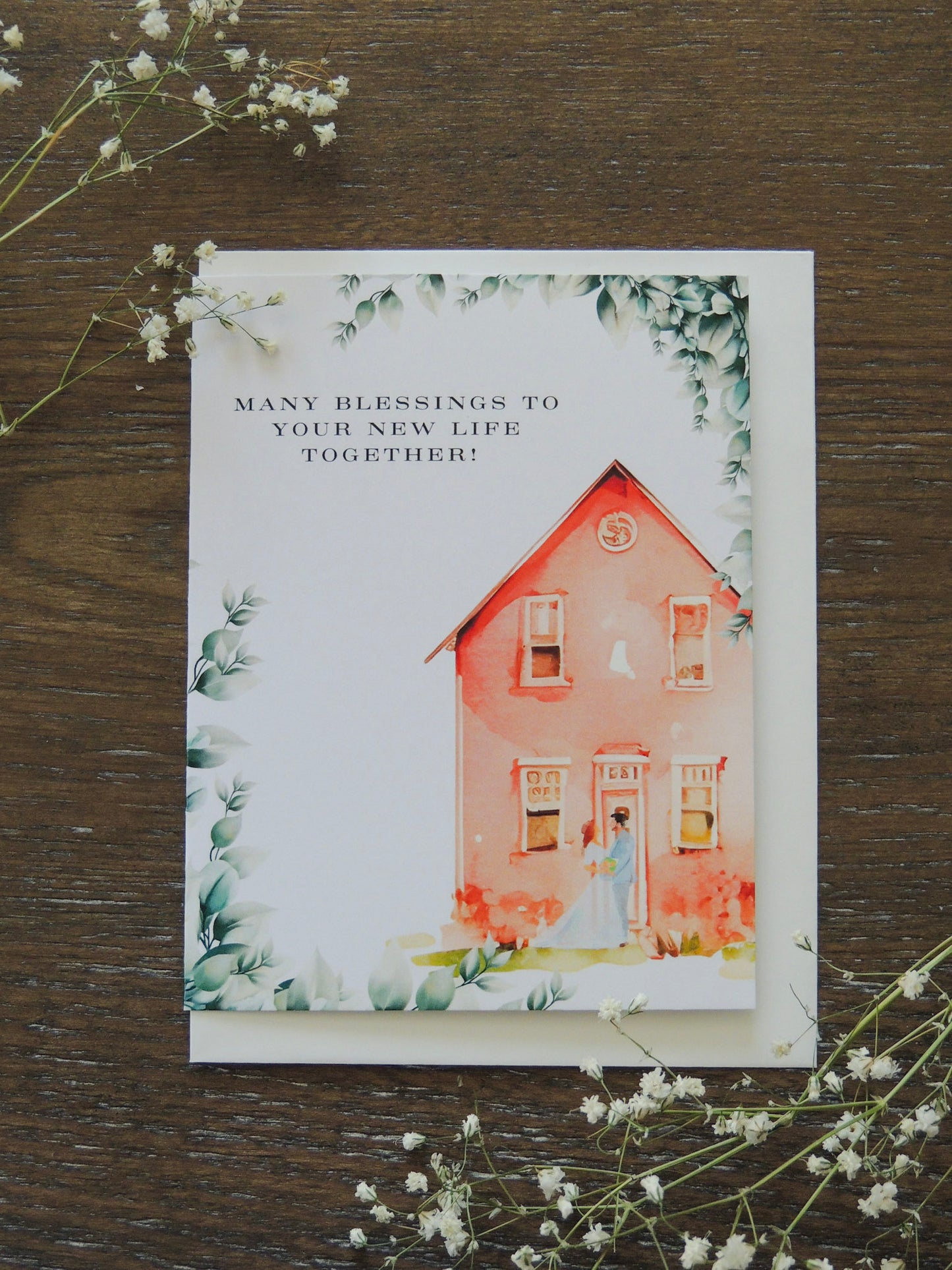 watercolor card with red house and couple with phrase "many blessings to your new life together"