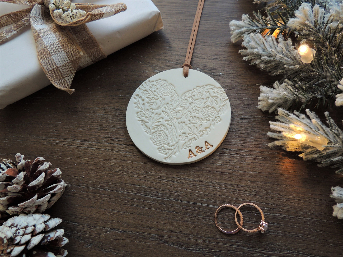 circular christmas tree ornament with heart design and initials