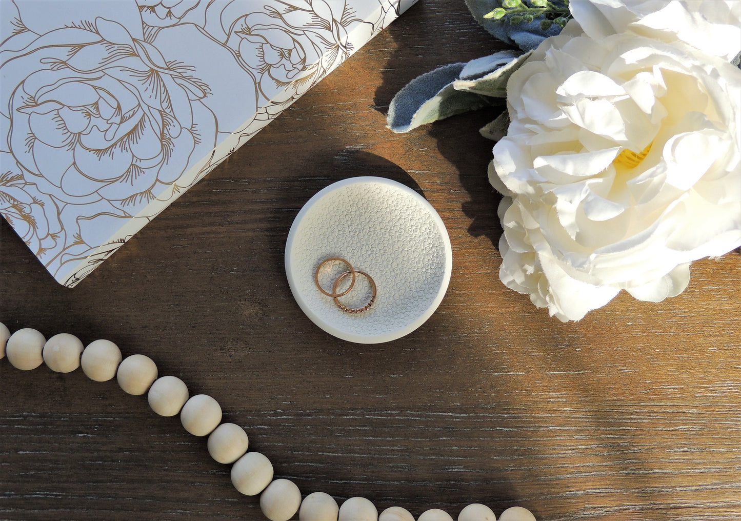 white ring dish with textured floral design, perfect for photography prop, flat lay kits