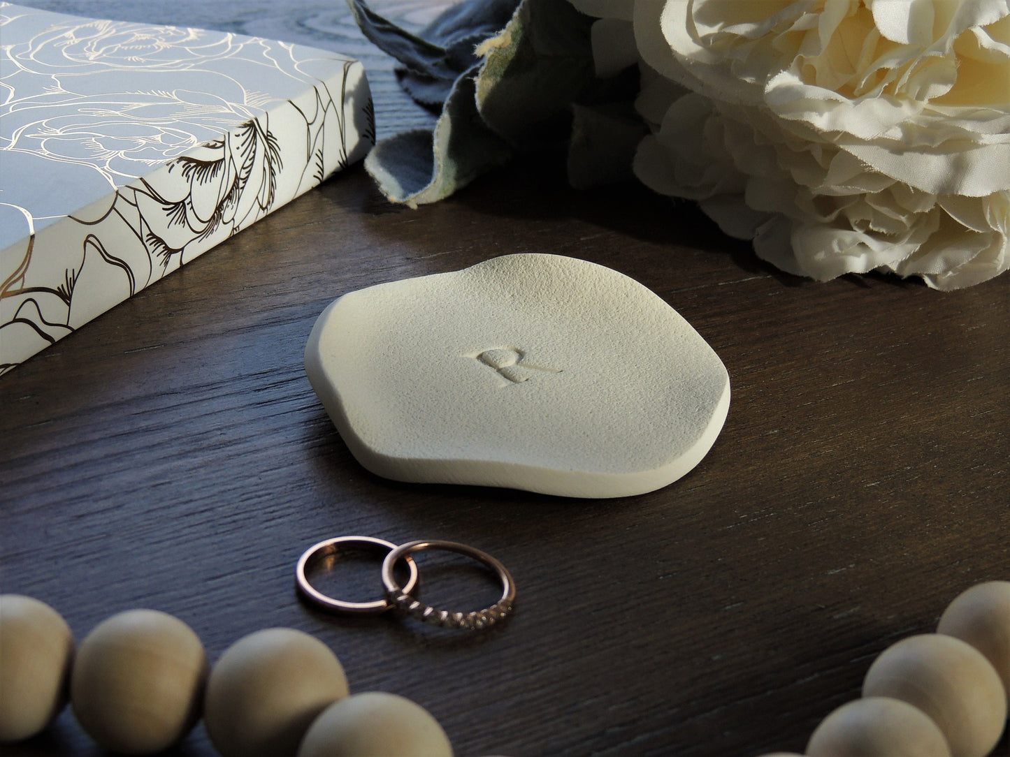 simple single letter ring dish with wavy natural edges