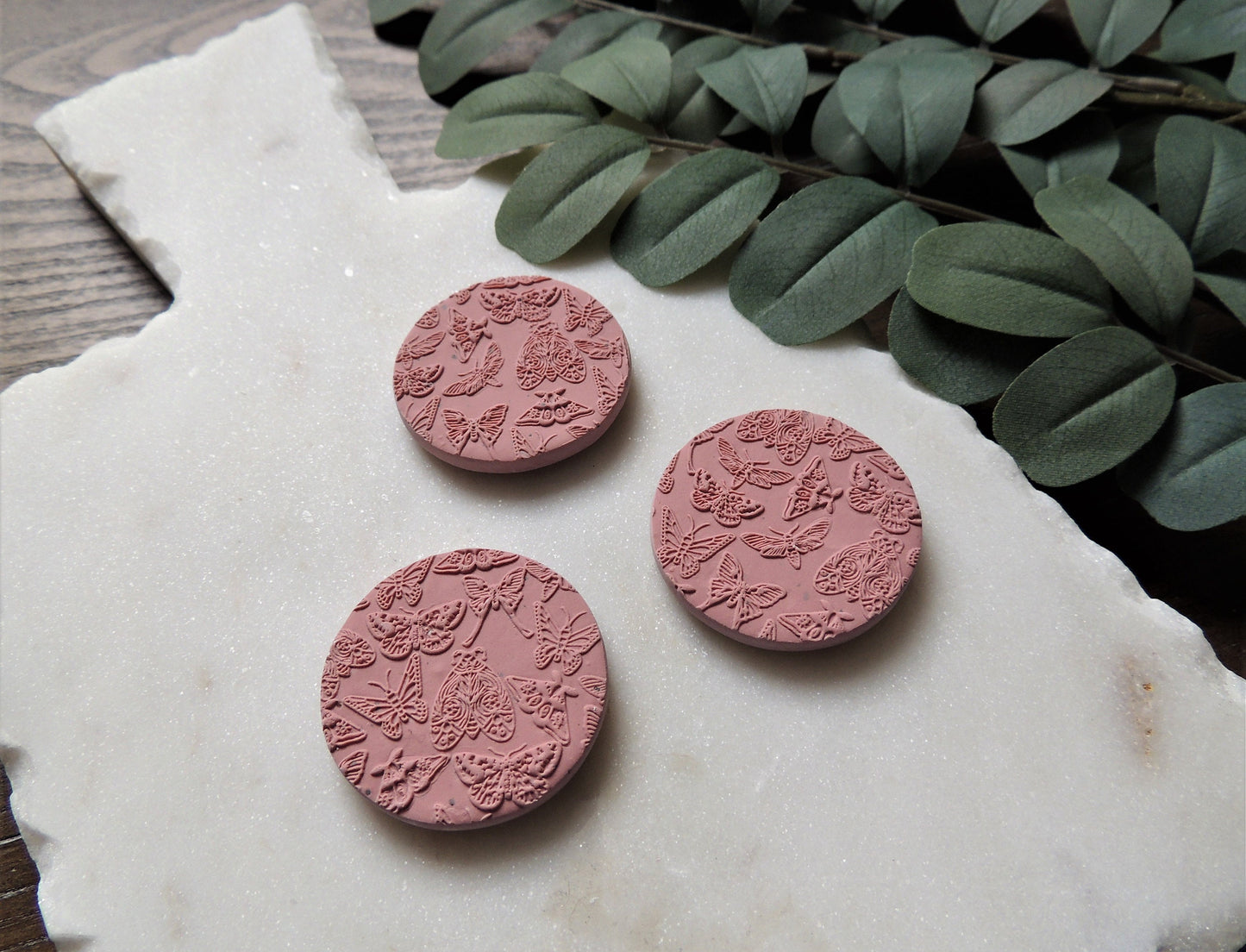 pink clay butterfly and moth magnets with 3D design