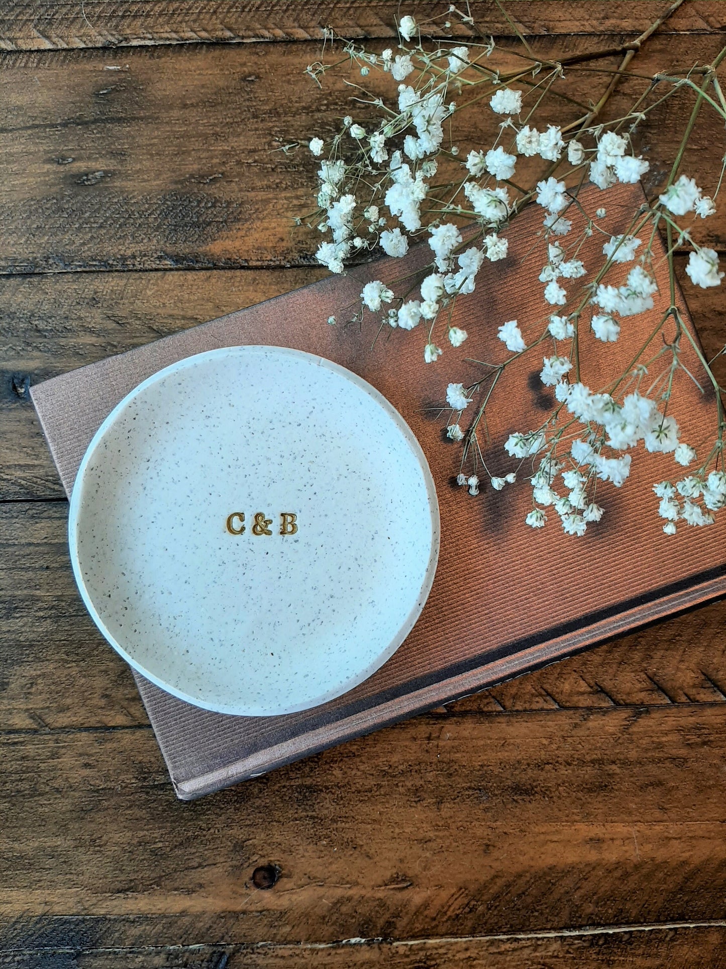 custom ring dish with speckled white and gold letters