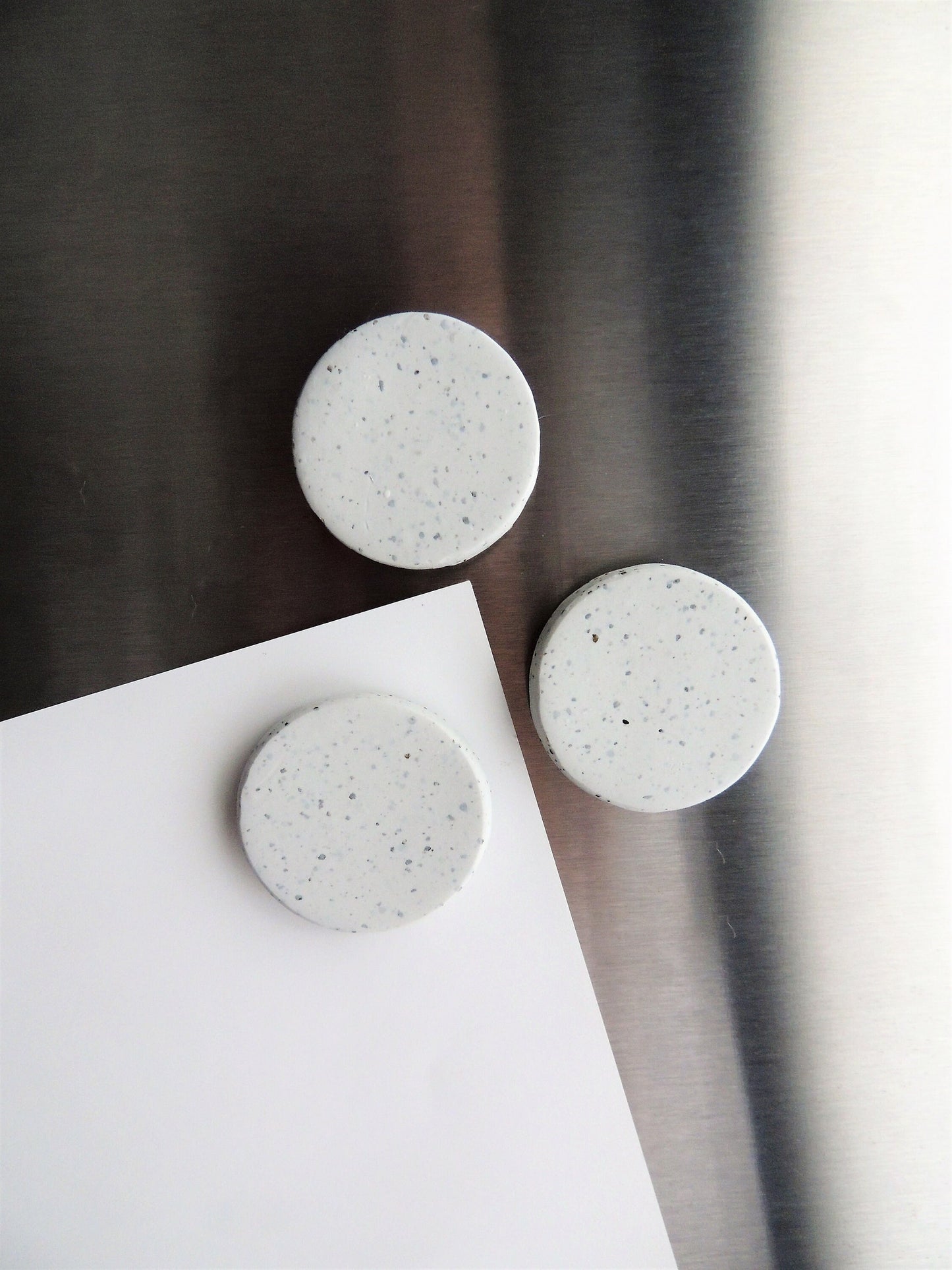 simple circular speckle clay magnets in white