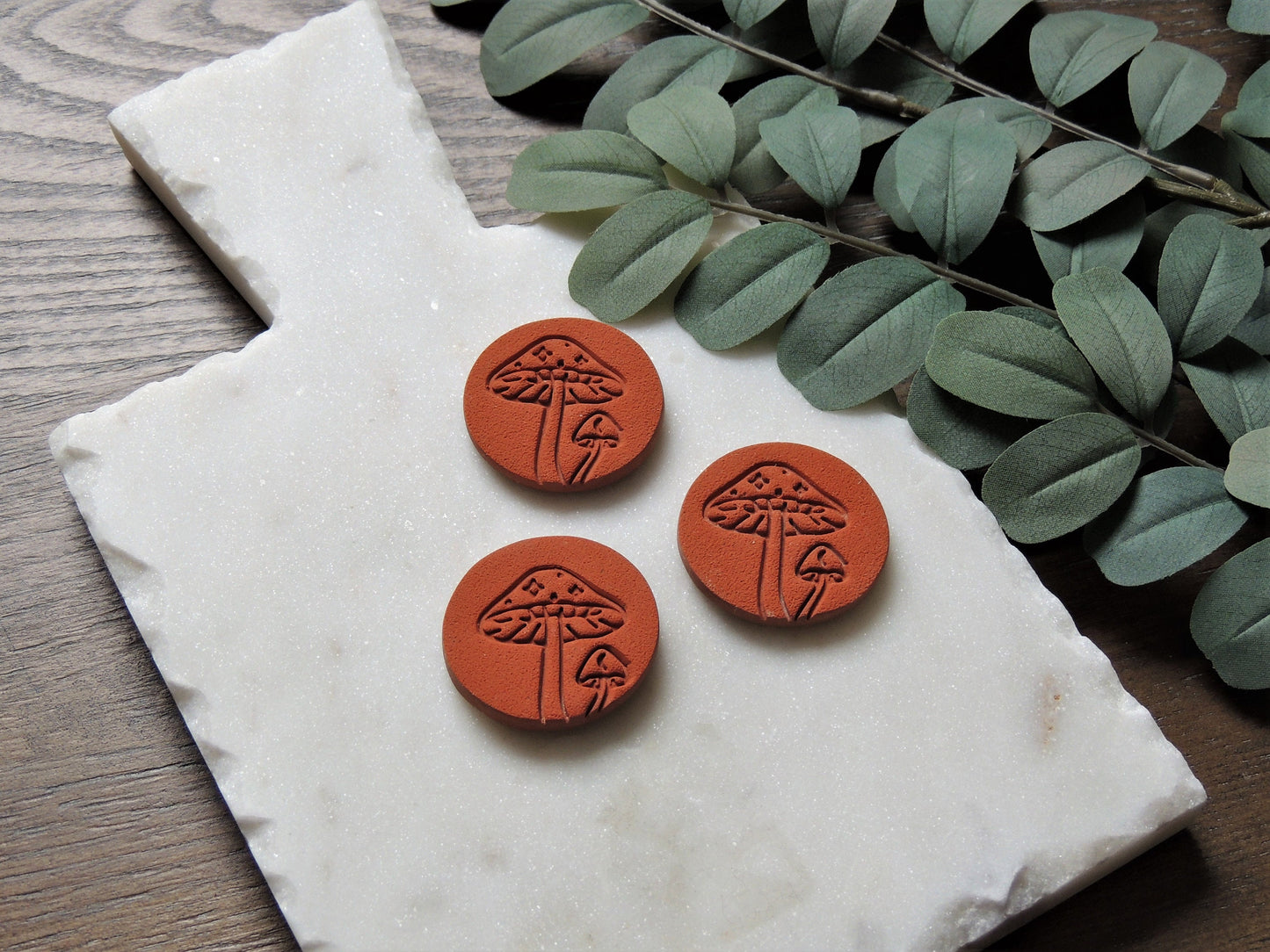 terracotta colored magnets with embossed mushroom design for house warming gift