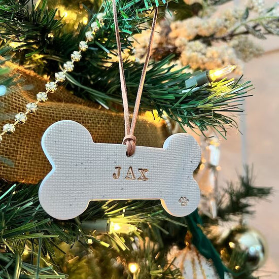 Dog bone shaped custom ornament with JAX on it 