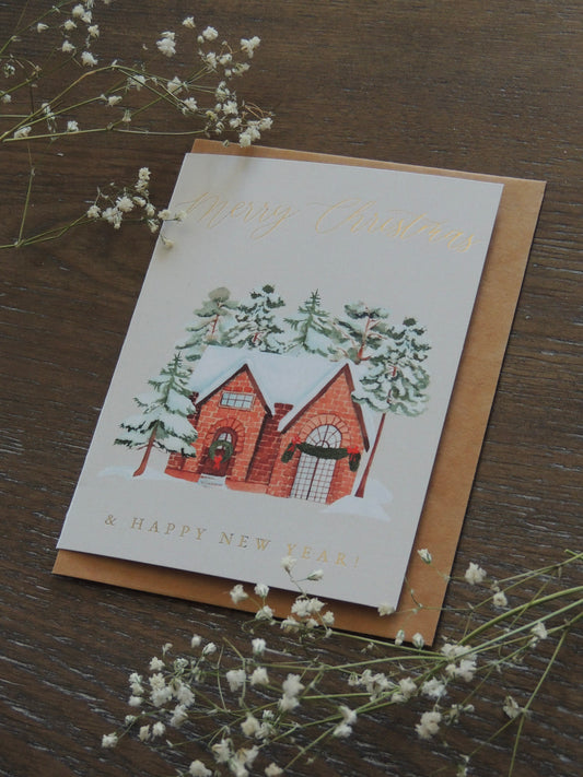 Christmas card with watercolor red brick house and phrase "Merry Christmas and Happy New Year"