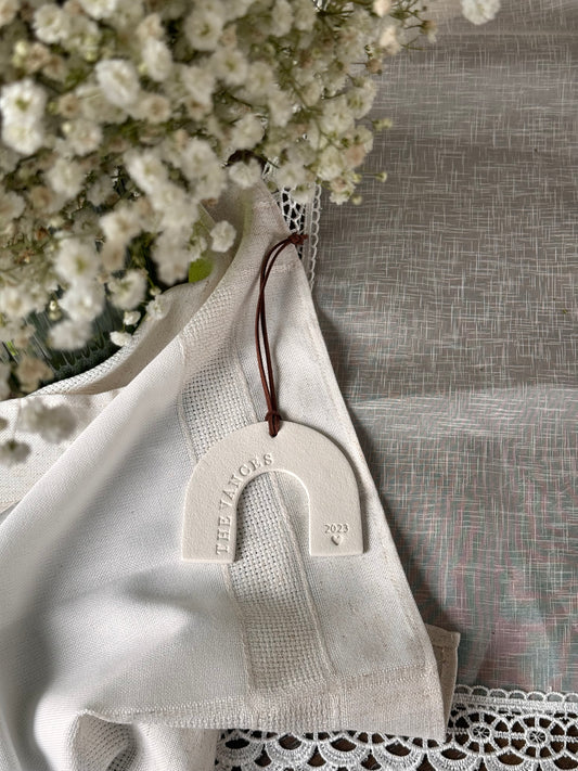 white rainbow curved ornament with custom family name and date