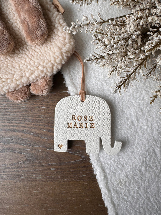 elephant shaped white clay ornament with personalized baby name with gold text