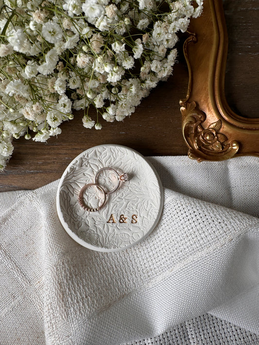 floral textured design ring dish made of white clay with custom initials in bottom right of dish