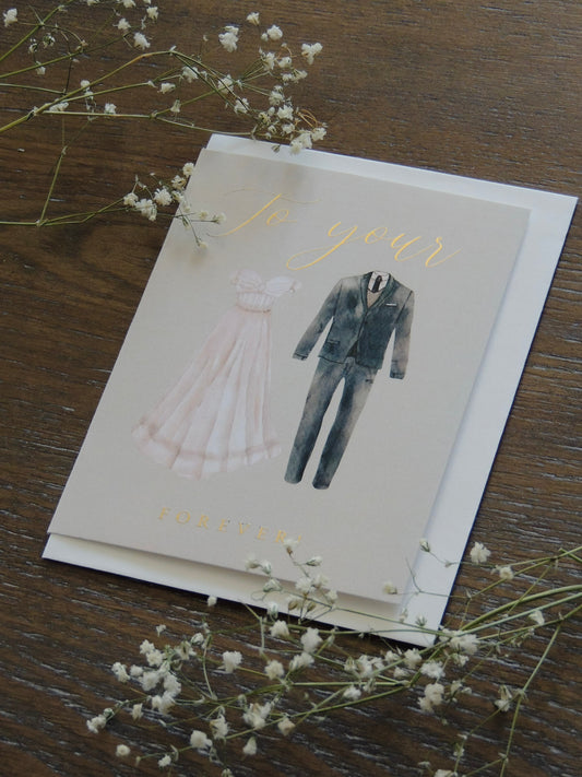 couple wedding card with dress and suit on front with phrase "to your forever" in gold foil