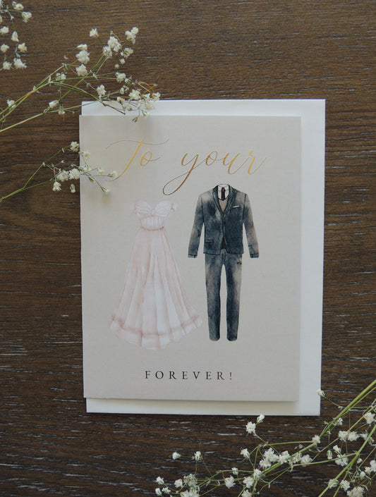 couple wedding card with dress and suit on front with phrase "to your forever" in gold foil