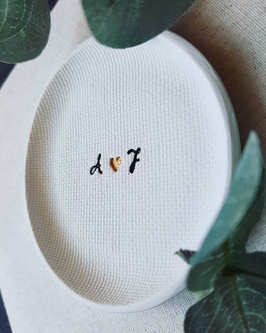 ring dish with black and gold writing in center made of white clay, gift for couples
