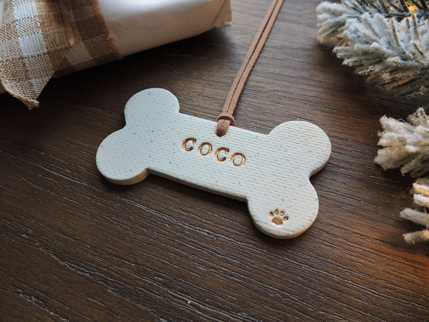 white dog bone ornament personalized with name and paw print