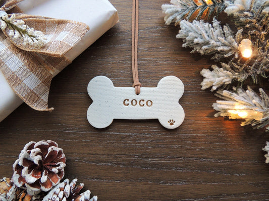 white dog bone ornament personalized with name and paw print