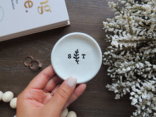 custom ring dish for wedding couple with initials and leaf design in center in black