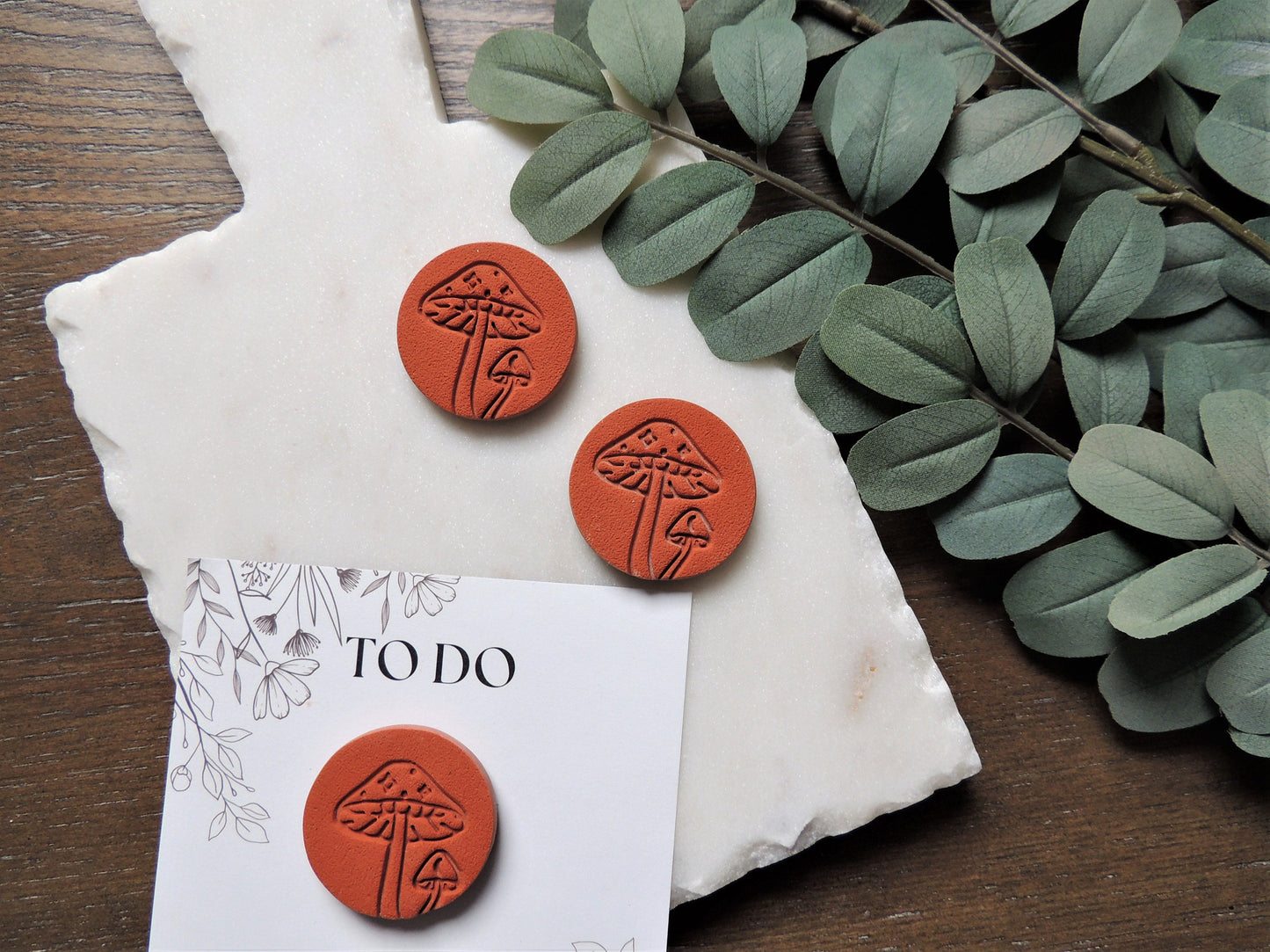 terracotta colored magnets with embossed mushroom design for house warming gift