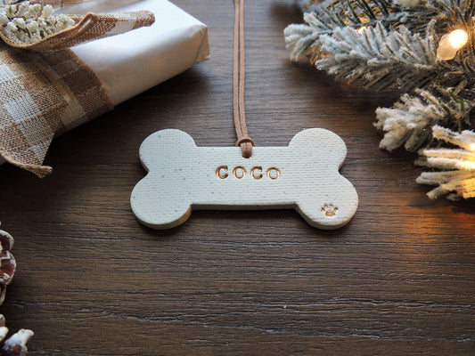 white dog bone ornament personalized with name and paw print