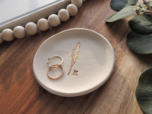 white clay ring dish with gold embossed wheat design and personalized initial
