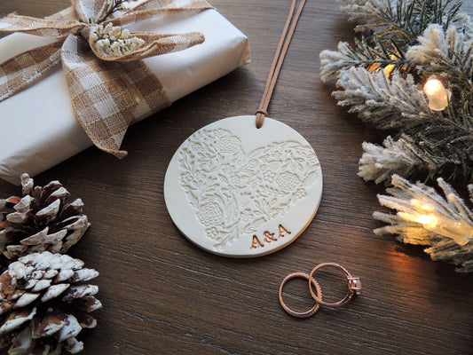 circular christmas tree ornament with heart design and initials