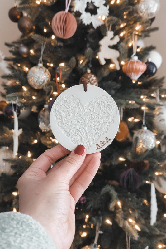 circular christmas tree ornament with heart design and initials