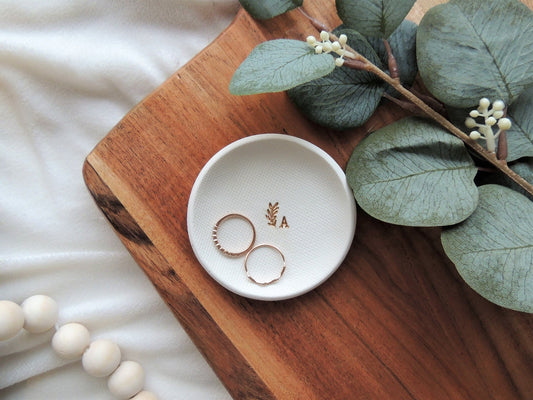 white clay ring dish with gold foil initial and small leaf design, very simple, gift for her