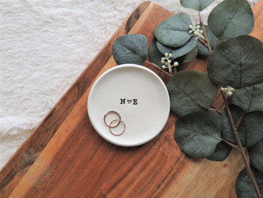 ring dish made of white clay with simple black initials in the center, perfect bridal gift