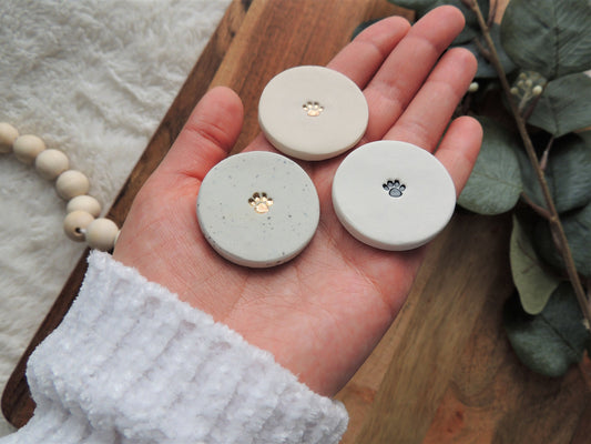 white magnet with paw print in center, pet themed