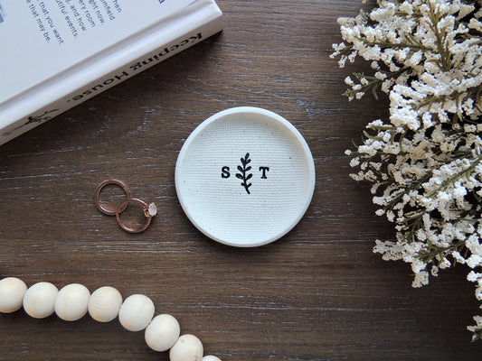 custom ring dish with black initials in center with leaf design, handmade from white clay in Edmonton