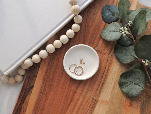 white clay ring dish with gold foil initial and small leaf design, very simple, gift for her