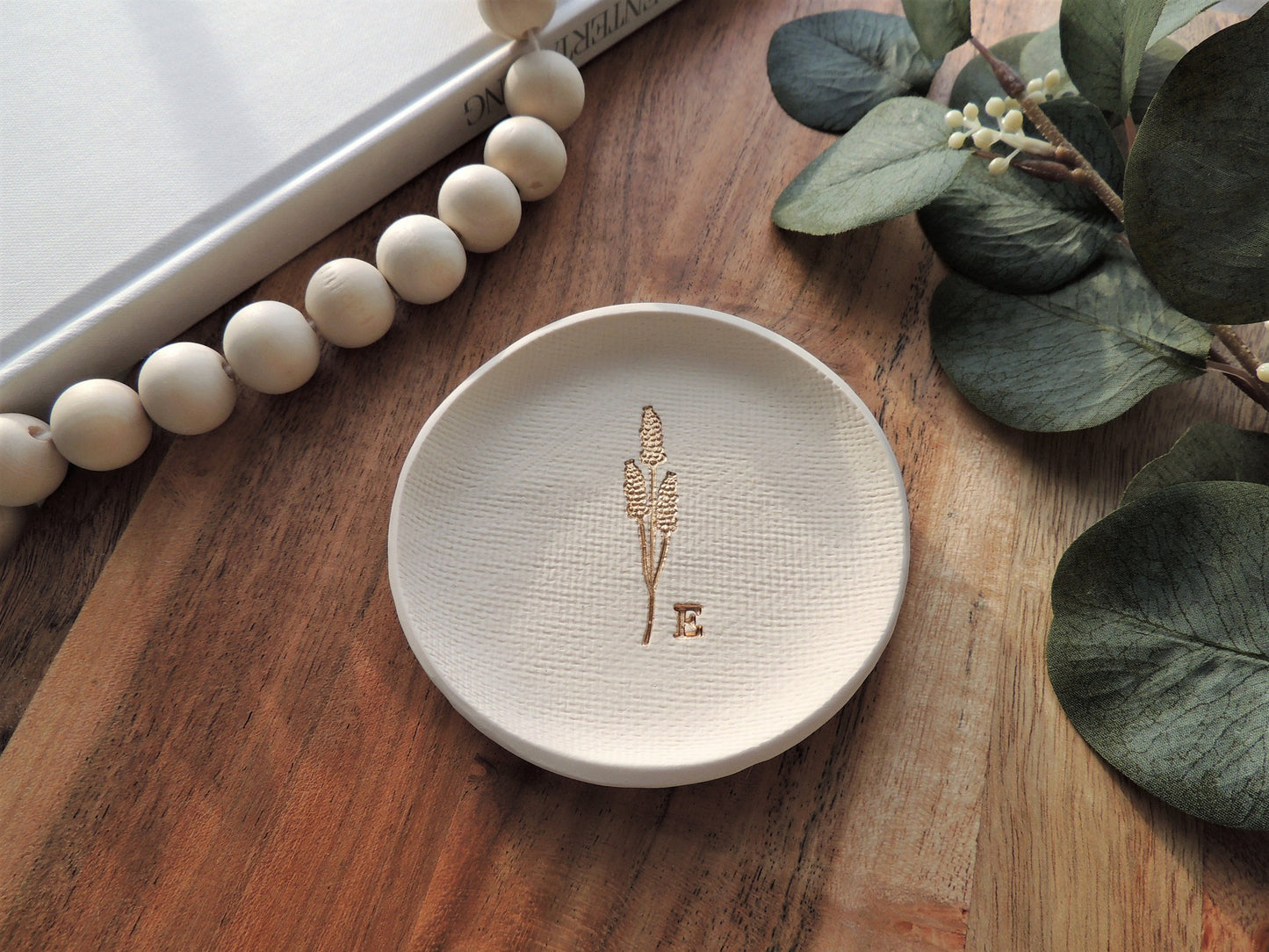 white clay ring dish with gold embossed wheat design and personalized initial