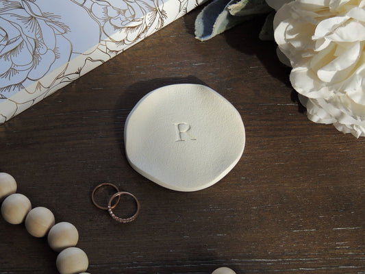 simple single letter ring dish with wavy natural edges
