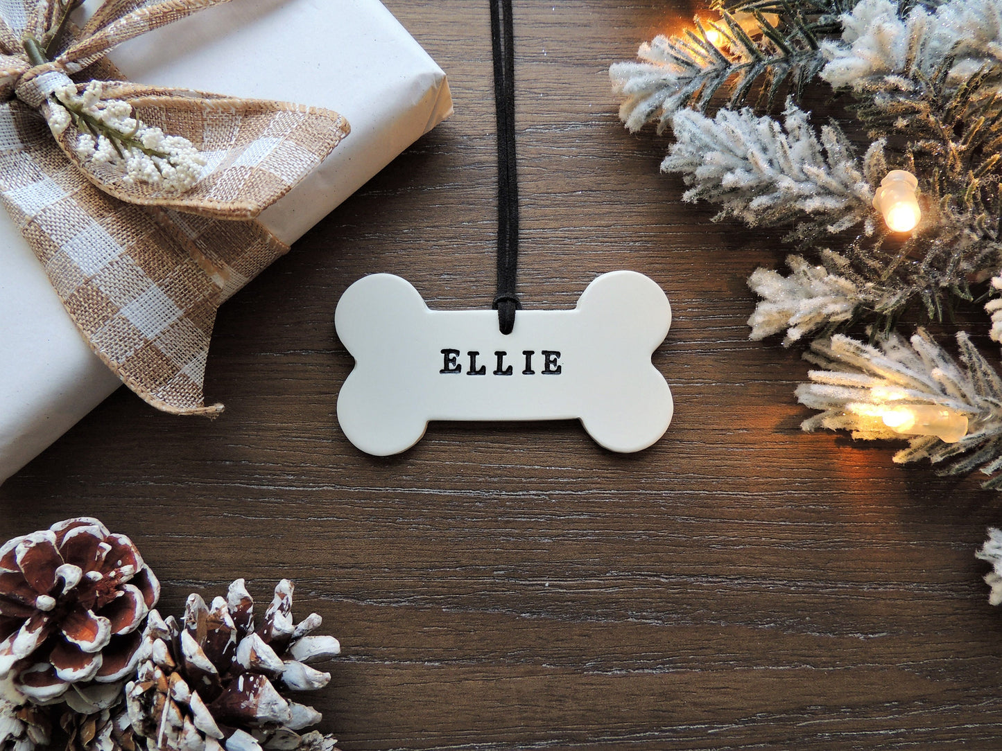 custom white bone shaped ornament for pet with name and paw print in black