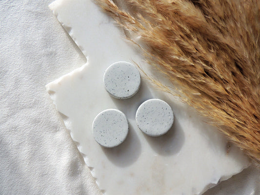 simple circular speckle clay magnets in white